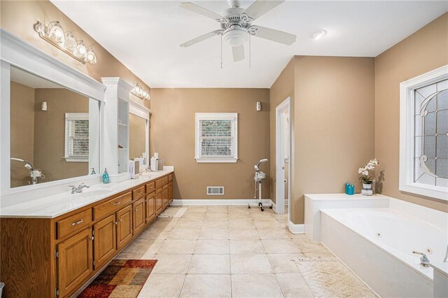 bathroom featuring tile patterned flooring, vanity, a shower with door, and ceiling fan