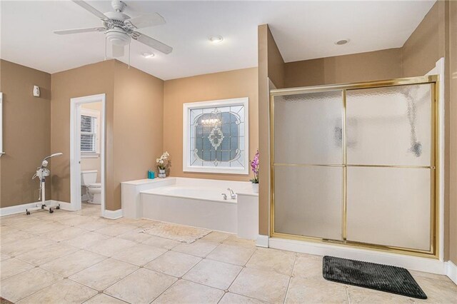 bathroom featuring tile patterned flooring, toilet, and shower with separate bathtub