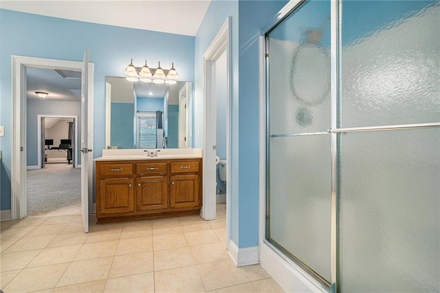 full bathroom with tile patterned flooring, a shower stall, vanity, and baseboards