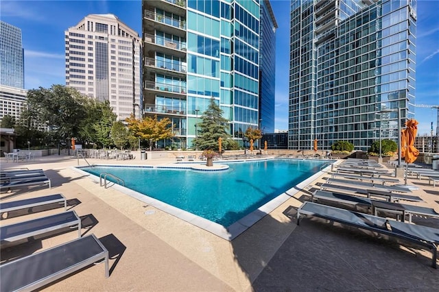 pool featuring a patio area and a view of city