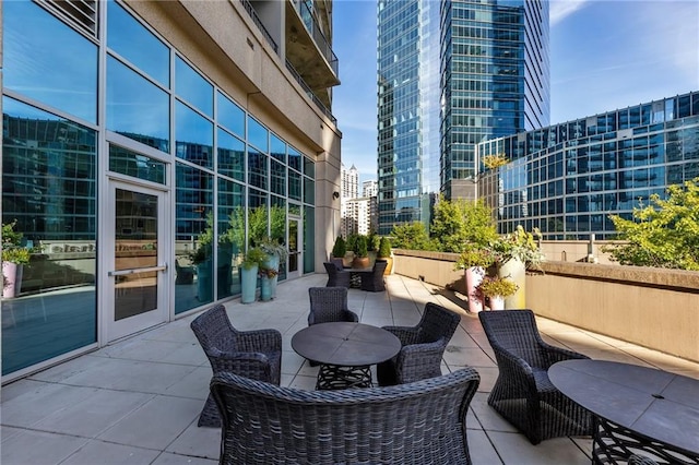 view of patio / terrace featuring a view of city and outdoor dining space