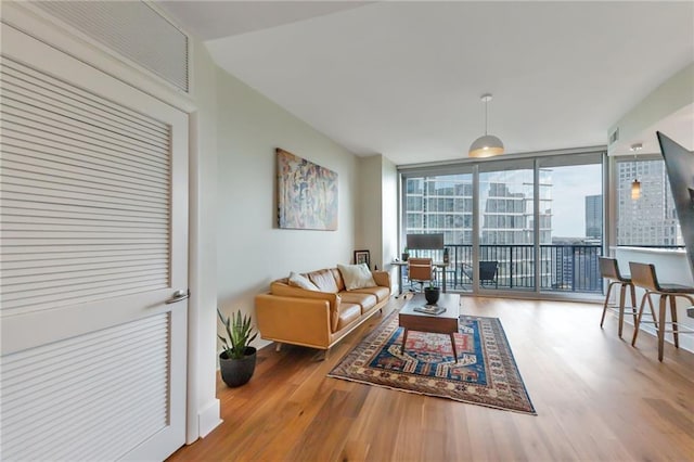 living room with wood finished floors and expansive windows