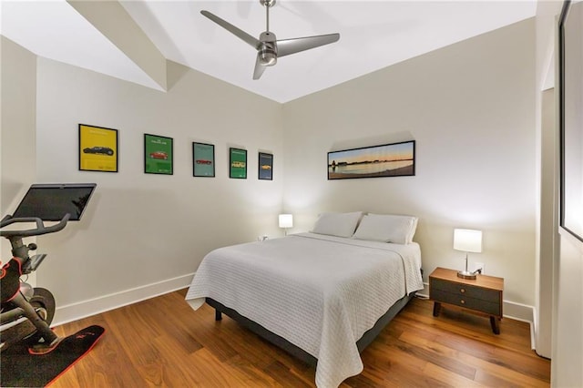 bedroom with wood finished floors, baseboards, and ceiling fan