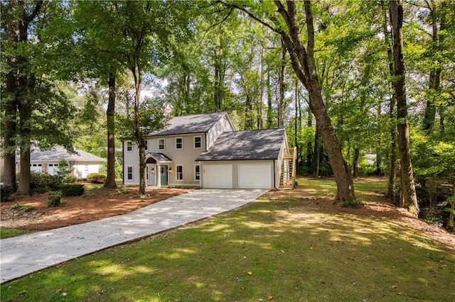 view of front of property with a garage and a front yard