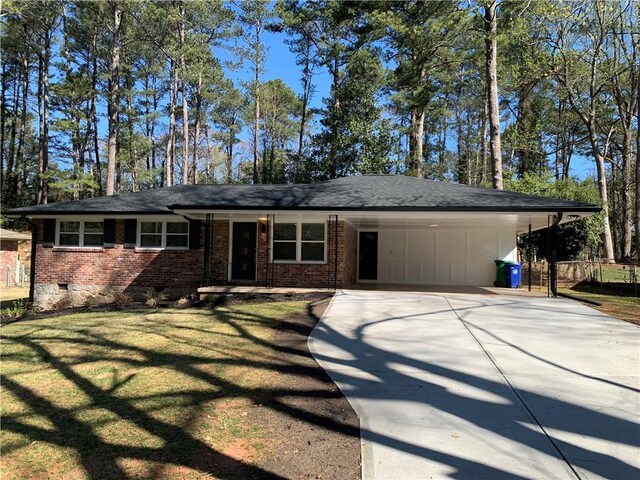 4430 Locksley Rd, Tucker, GA 30084 - ranch-style house featuring brick siding, a front lawn, an attached carport, and driveway