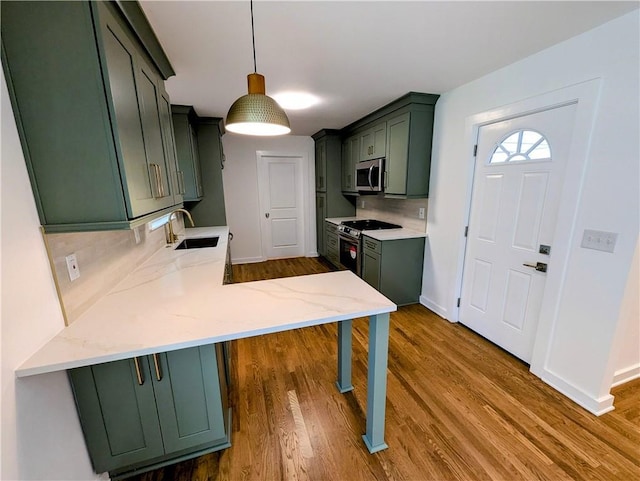 4430 Locksley Rd, Tucker, GA 30084 - kitchen with tasteful backsplash, green cabinets, a peninsula, stainless steel appliances, and a sink