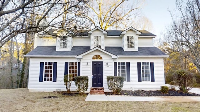 cape cod home with a front lawn