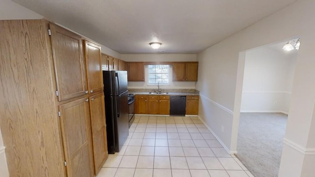 kitchen with sink, black appliances, and light tile patterned flooring