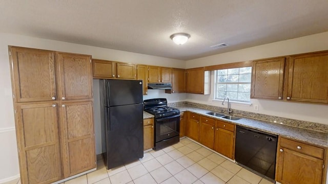 kitchen with light tile patterned flooring, sink, and black appliances