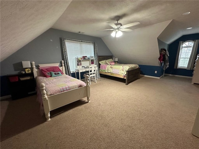 bedroom with carpet flooring, ceiling fan, a textured ceiling, and vaulted ceiling