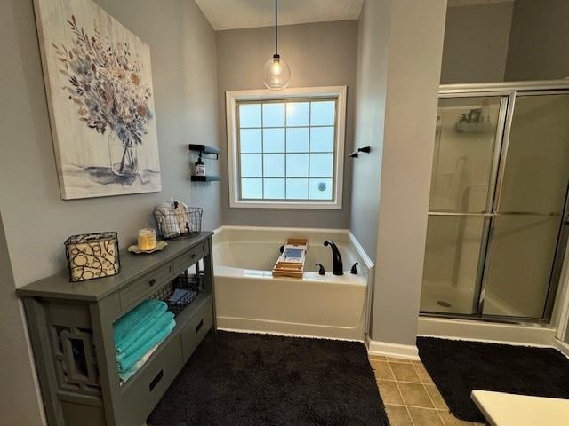 bathroom with tile patterned floors and independent shower and bath