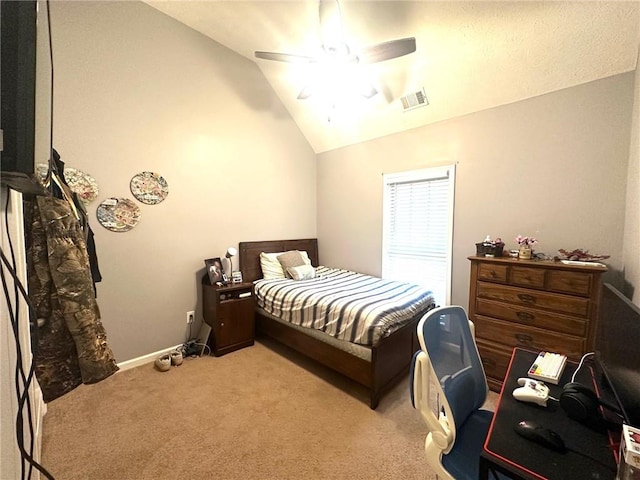 carpeted bedroom with ceiling fan and vaulted ceiling