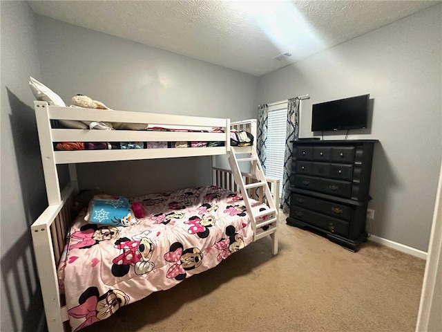 carpeted bedroom with a textured ceiling