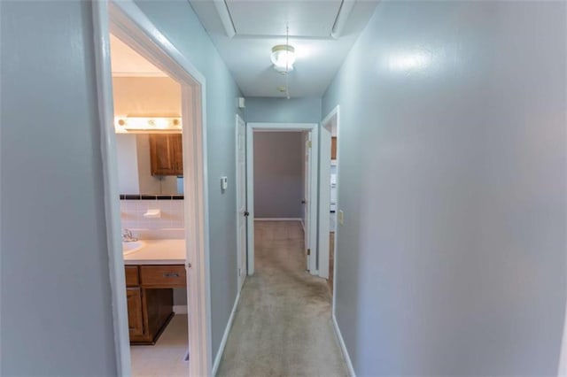 hallway with light colored carpet