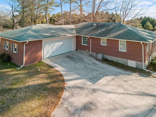 view of side of home with a garage, a lawn, and central air condition unit