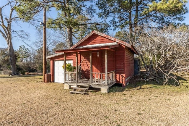 view of outdoor structure with a yard and a garage