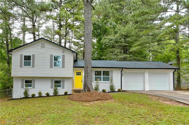 tri-level home with a front yard and a garage