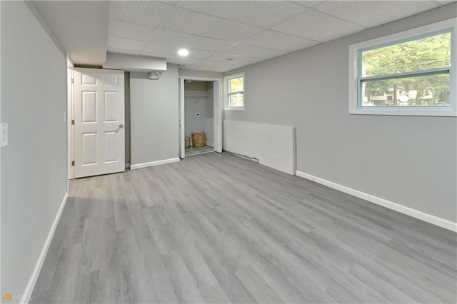 basement with a drop ceiling and hardwood / wood-style floors