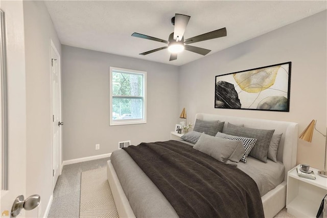 bedroom featuring light carpet and ceiling fan