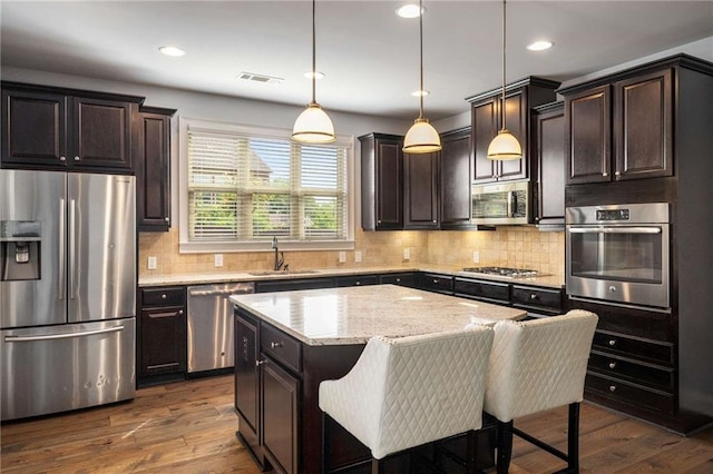 1520 Gallant Fox Ln, Suwanee, GA 30024 - kitchen featuring stainless steel appliances, a sink, dark brown cabinetry, recessed lighting, and dark wood-style floors