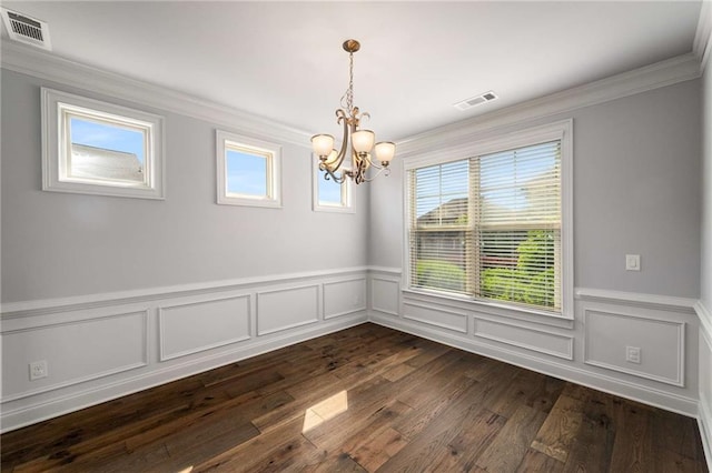 1520 Gallant Fox Ln, Suwanee, GA 30024 - spare room with a chandelier, ornamental molding, healthy amount of natural light, dark wood finished floors, and a wainscoted wall