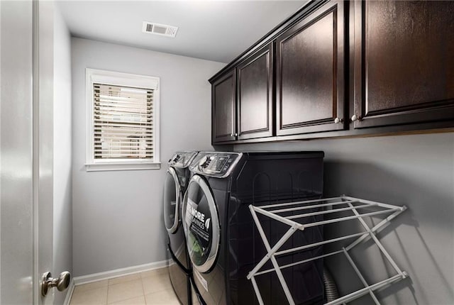 1520 Gallant Fox Ln, Suwanee, GA 30024 - washroom with washing machine and clothes dryer, cabinet space, baseboards, and light tile patterned flooring