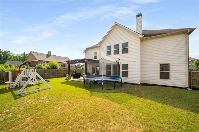 1520 Gallant Fox Ln, Suwanee, GA 30024 - back of house featuring a trampoline, a playground, and a chimney