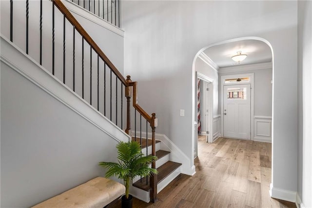 1520 Gallant Fox Ln, Suwanee, GA 30024 - foyer with ornamental molding, arched walkways, wood finished floors, and stairway