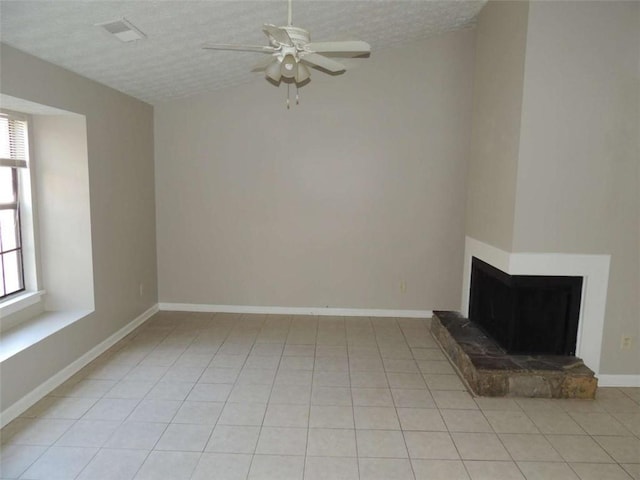 unfurnished living room with light tile patterned floors, a textured ceiling, ceiling fan, and lofted ceiling