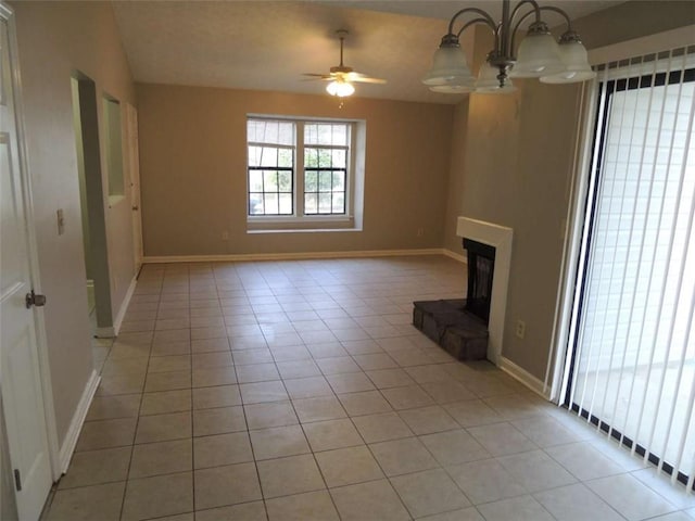 unfurnished living room featuring light tile patterned floors and ceiling fan with notable chandelier