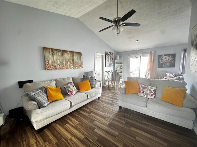 living room with vaulted ceiling, a textured ceiling, ceiling fan with notable chandelier, and dark wood finished floors