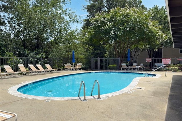 3210 Lake Pointe Cir, Roswell, GA 30075 - community pool featuring a patio area and view of scattered trees
