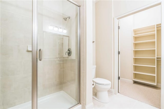 3621 Vinings Slope SE Unit 3510, Atlanta, GA 30339 - full bath featuring a stall shower, toilet, a spacious closet, and baseboards