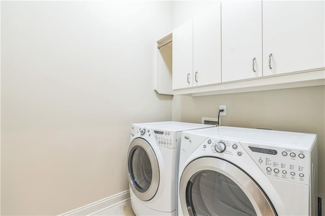 3621 Vinings Slope SE Unit 3510, Atlanta, GA 30339 - laundry room featuring cabinet space, washing machine and clothes dryer, and baseboards