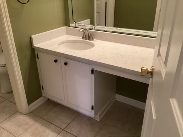 bathroom with vanity, toilet, and tile patterned flooring