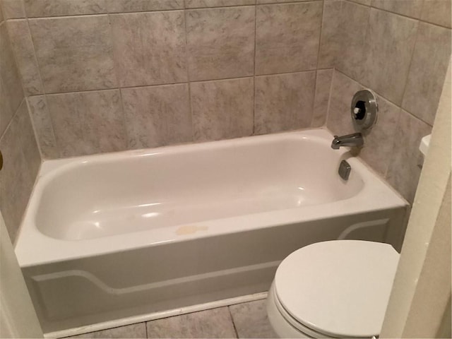 bathroom with toilet and tile patterned flooring