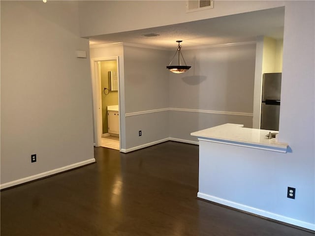 interior space featuring crown molding and dark hardwood / wood-style flooring