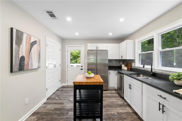 96 Senoia Rd, Fairburn, GA 30213 - kitchen featuring appliances with stainless steel finishes, plenty of natural light, butcher block countertops, white cabinets, and recessed lighting