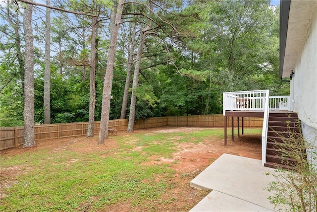 96 Senoia Rd, Fairburn, GA 30213 - fenced backyard featuring stairs, a wooden deck, and a patio area
