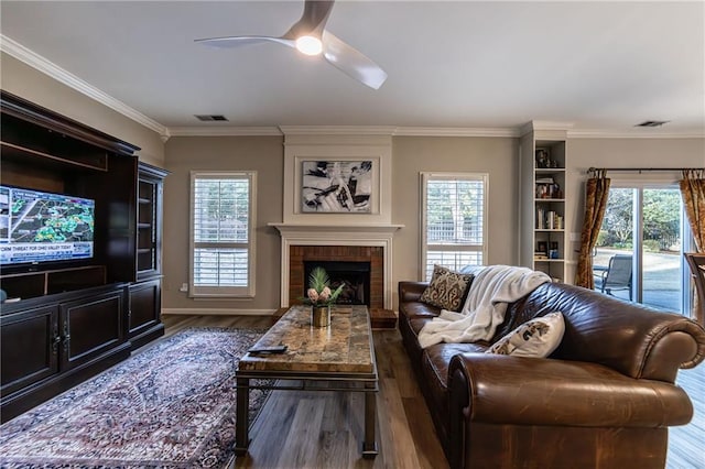 living room featuring plenty of natural light, visible vents, and wood finished floors