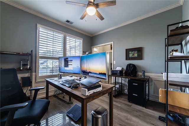 office with a ceiling fan, visible vents, wood finished floors, and ornamental molding