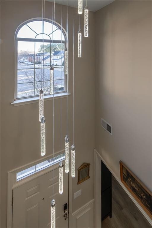 foyer with visible vents and wood finished floors