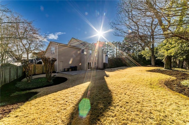 view of side of home with a patio and fence