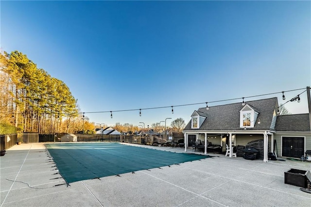 community pool featuring a patio area and fence