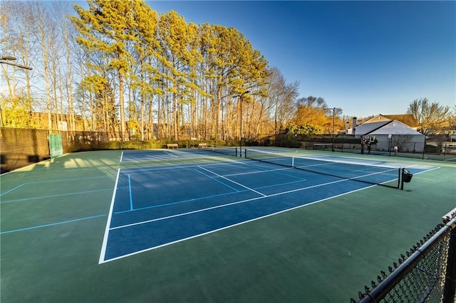 view of tennis court with fence