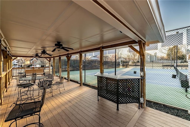 wooden deck with a ceiling fan and fence