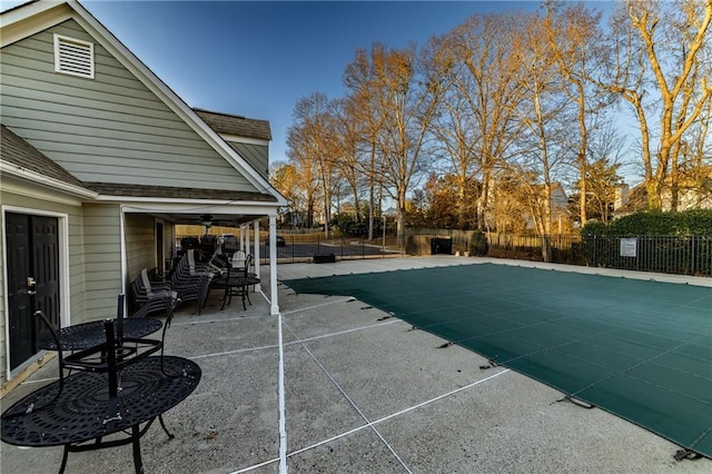 pool with a patio area and a fenced backyard