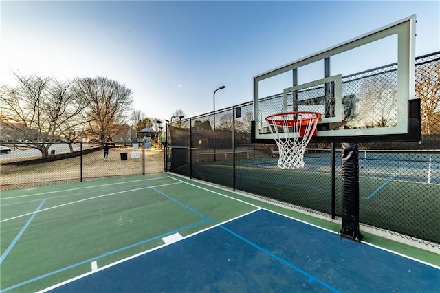 view of basketball court featuring community basketball court and fence