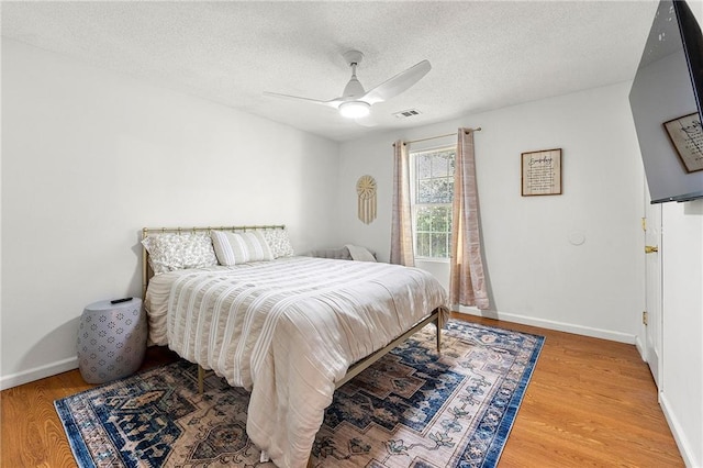 1357 Railroad Ave, Sugar Hill, GA 30518 - bedroom featuring wood finished floors, a textured ceiling, ceiling fan, and baseboards