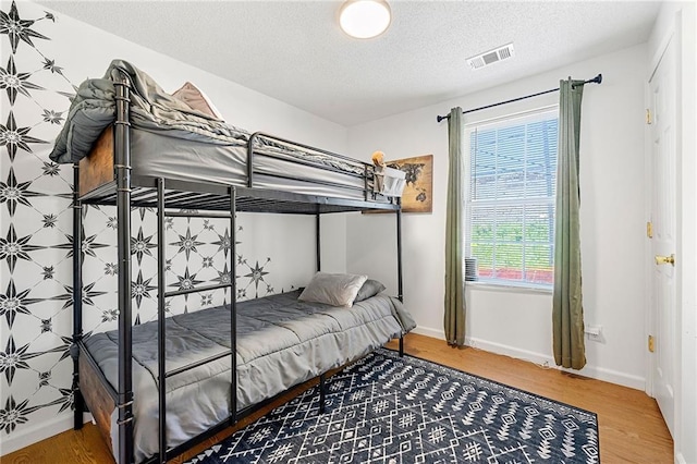1357 Railroad Ave, Sugar Hill, GA 30518 - bedroom featuring a textured ceiling, wood finished floors, and baseboards